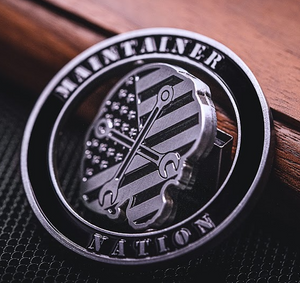 Maintainer Nation Spinner Coin with spinning skull and wrenches. A challenge coin with a rustic, hammered texture. Military coin with an antique brass finish.