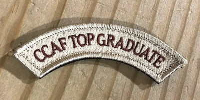  CCAF TOP GRADUATE Embroidered Patch from Challenge Coin Nation on a wooden surface