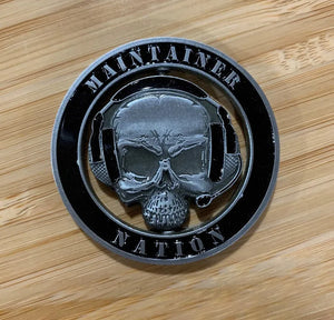 MX Spinner Coin with die-cut center skull and headset logo on wooden surface, from Challenge Coin Nation