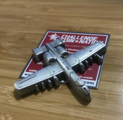  A-10 Challenge Coin from Challenge Coin Nation displayed with product card on a wooden surface