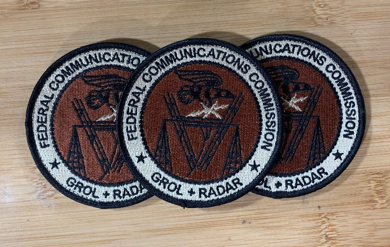  Three embroidered GROL RADAR Patches from Challenge Coin Nation on a wooden surface