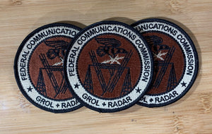  Three embroidered GROL RADAR Patches from Challenge Coin Nation on a wooden surface