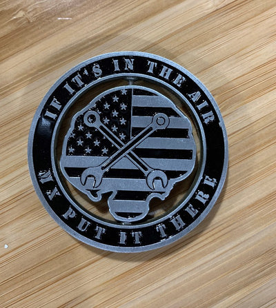 Back of MX Spinner Coin with die-cut center American flag and crossed wrenches on wooden surface, from Challenge Coin Nation