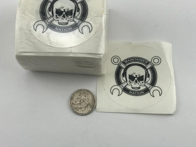  Tall stack of MX Nation Logo Stickers with “Maintainer Nation” and skull and “cross wrenches” design from Challenge Coin Nation, with one sticker removed for display and a quarter for scale